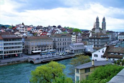 Buildings in city against cloudy sky