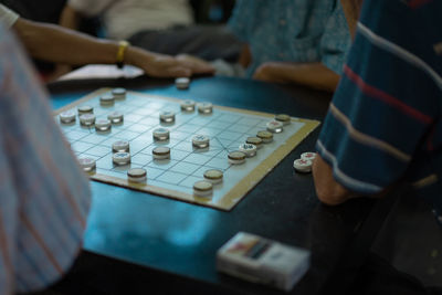 Midsection of people playing leisure game