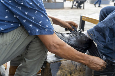 Midsection of man working in workshop