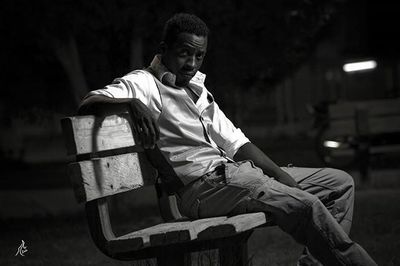 Portrait of young man sitting on seat