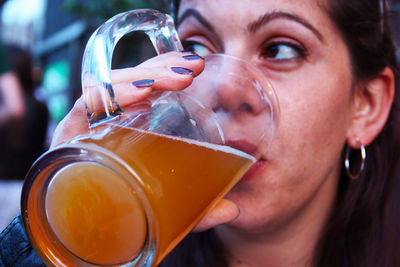 Close-up portrait of a woman drinking glass