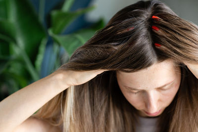 Close-up of woman with hand in hair