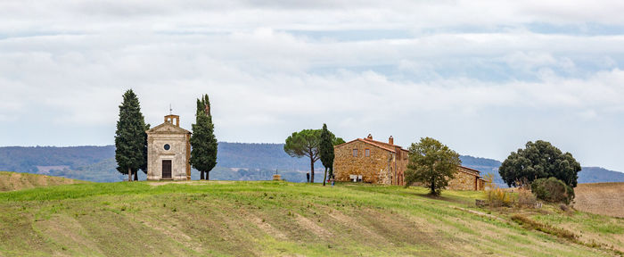 Built structure on field against sky