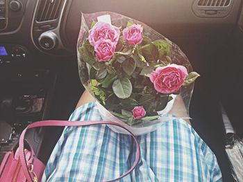 Woman holding pink flowers