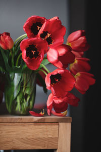 Close-up of red roses in vase on table