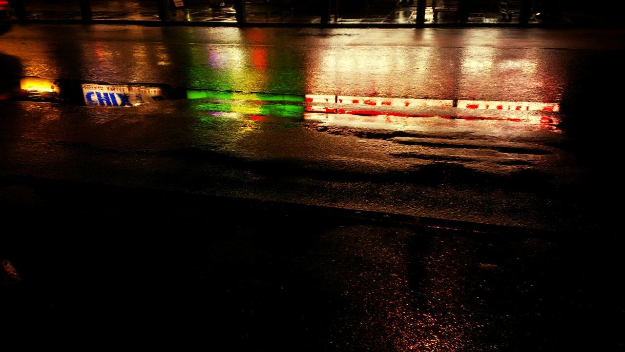 night, illuminated, text, street, dark, indoors, high angle view, reflection, western script, water, no people, transportation, road, communication, wet, close-up, guidance, light - natural phenomenon, rain