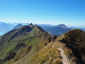 Scenic view of mountains against clear blue sky