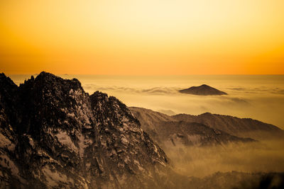 Scenic view of rocky mountains against sky during sunset