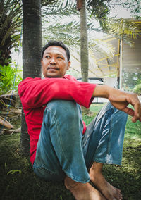 Portrait of man standing against trees