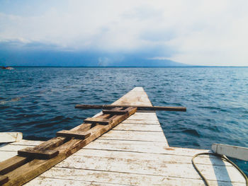 Pier over sea against sky