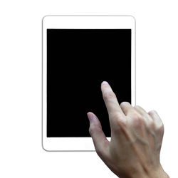 Close-up of hand touching smart phone against white background