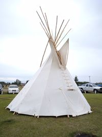 Windmill on field against sky