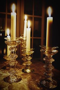 Close-up of illuminated candles on table
