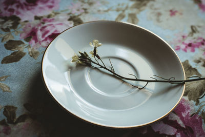 Flower in a plate on a flowered background