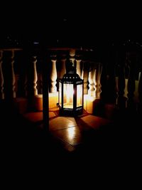 Illuminated lantern hanging in building at night