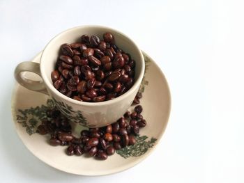 High angle view of roasted coffee beans in bowl