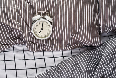 High angle view of clock on bed at home