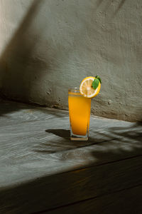 Close-up of drink on table against wall