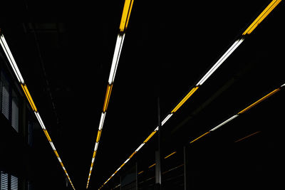 Rows of white and yellow lights inside dark warehouse, stuttgart, germany