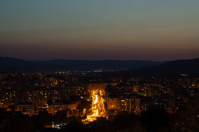 High angle view of illuminated buildings against sky at sunset