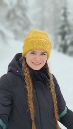 Portrait of smiling woman in snow