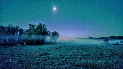 Scenic view of field against sky at night