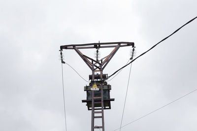 Low angle view of telephone pole against sky