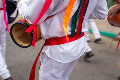 Low view of members of the marujada de curaca dancing during the chegancas meeting parade 