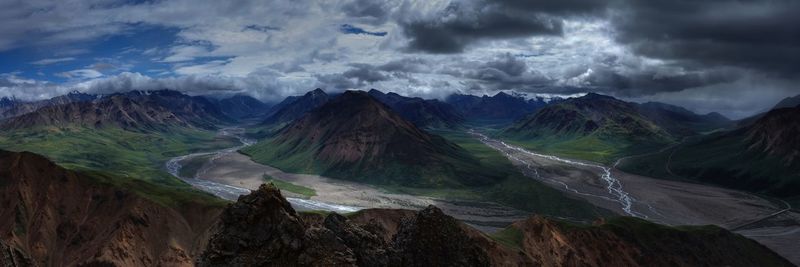 Panoramic view of mountains against cloudy sky