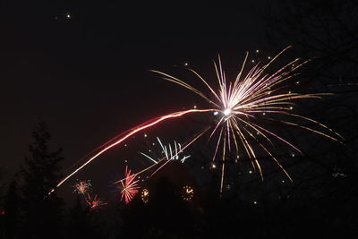 Low angle view of firework display at night