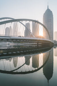 Reflection of bridge in city