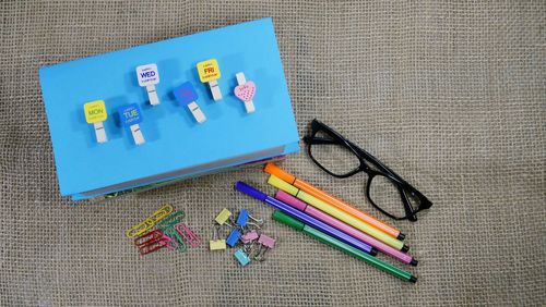 High angle view of colorful office supplies on table