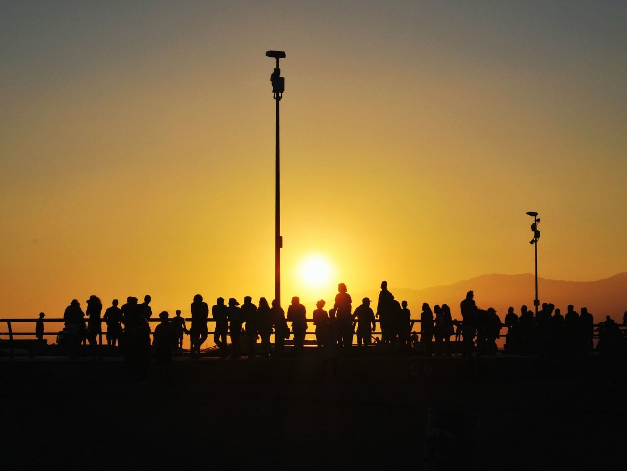 SILHOUETTE PEOPLE AGAINST ORANGE SKY