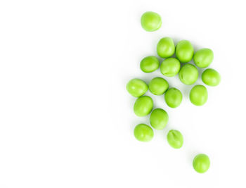 High angle view of green fruit over white background