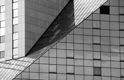 Low angle view of modern glass building in city