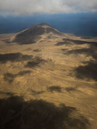 Scenic view of sand dunes against sky