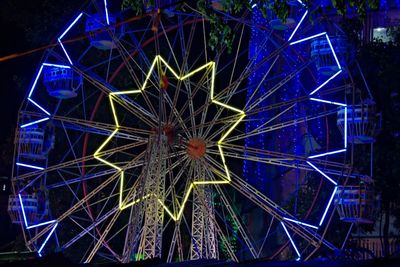 Low angle view of illuminated ferris wheel at night