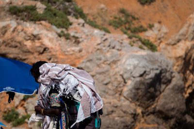 Side view of man carrying luggage