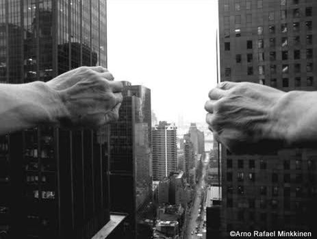 DIGITAL COMPOSITE IMAGE OF MAN AND WOMAN AGAINST BUILDINGS