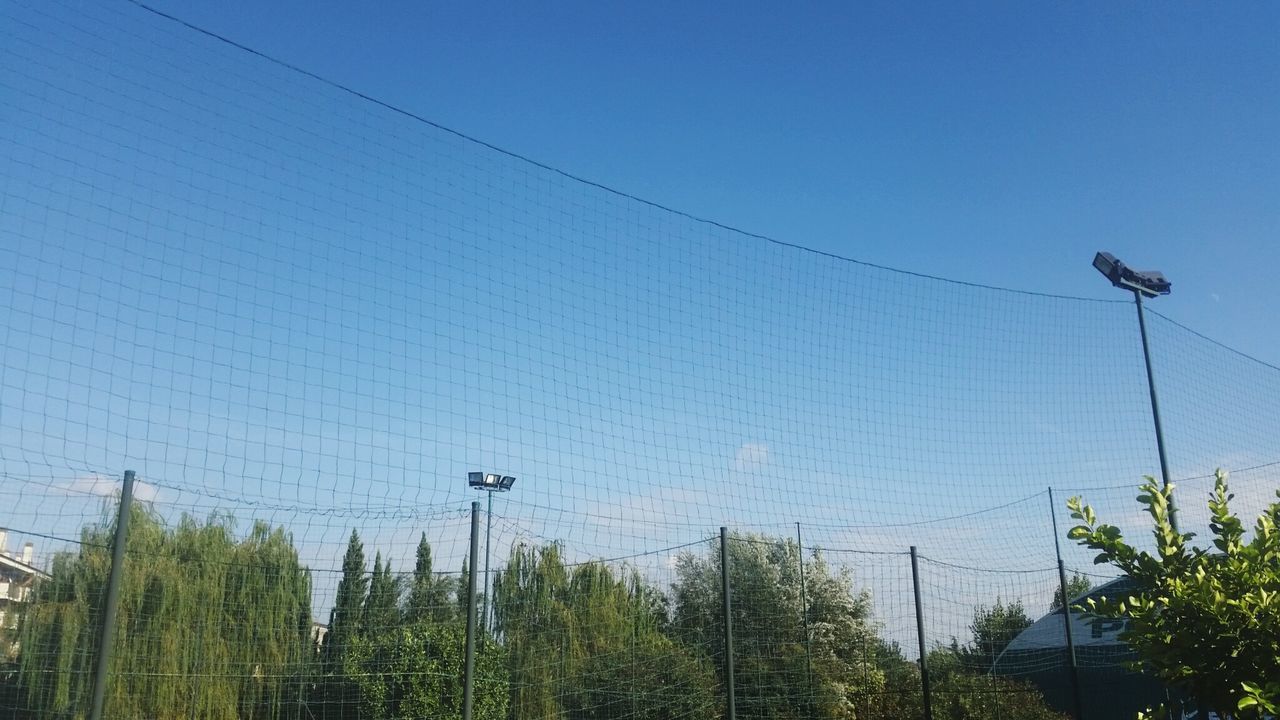 LOW ANGLE VIEW OF POWER LINES AGAINST CLEAR BLUE SKY