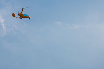 Low angle view of airplane flying against sky