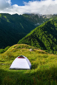 Camping in a tent with a view of the mountains.