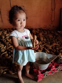 Portrait of cute girl standing indoors