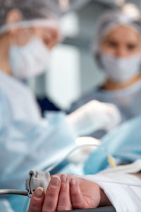 Midsection of doctor examining patient