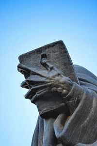 Low angle view of statue against clear blue sky