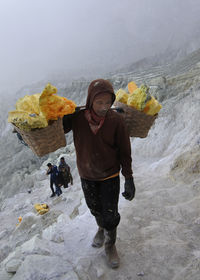 Woman standing on snow covered landscape during winter