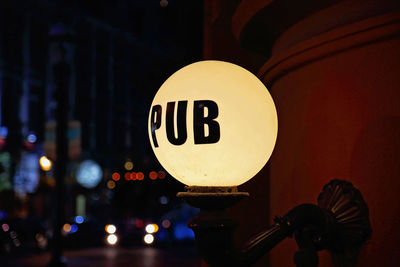 Low angle view of illuminated information sign on street