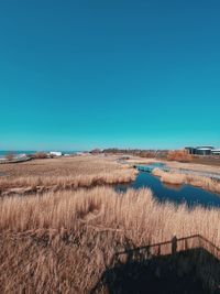 Scenic view of land against clear blue sky