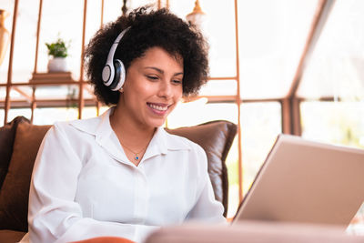 Businesswoman using laptop at table