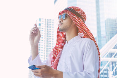 Midsection of young man looking at camera